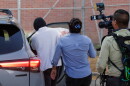 Immigration and Customs Enforcement officer Christian Castro gets into a car surrounded by news reporters moments after being released from the Carrizalez-Rucker Cameron County Detention Center in Brownsville, Texas on Aug. 27, 2026.