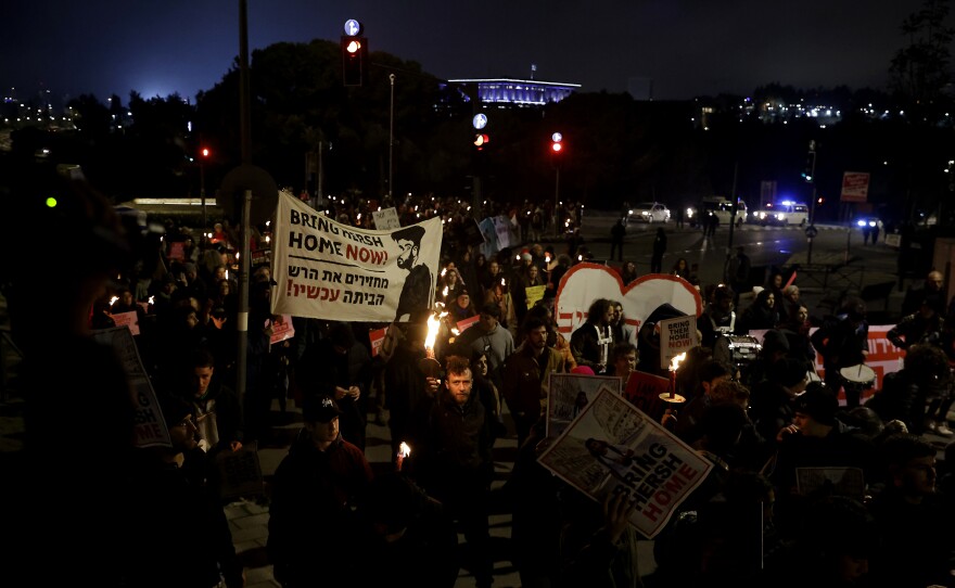 Protesters , in front of the Knesset, Israel's parliament, hold torches during a march demanding the release of hostages held by Hamas in the Gaza Strip on Feb. 19 in Jerusalem, Israel.
