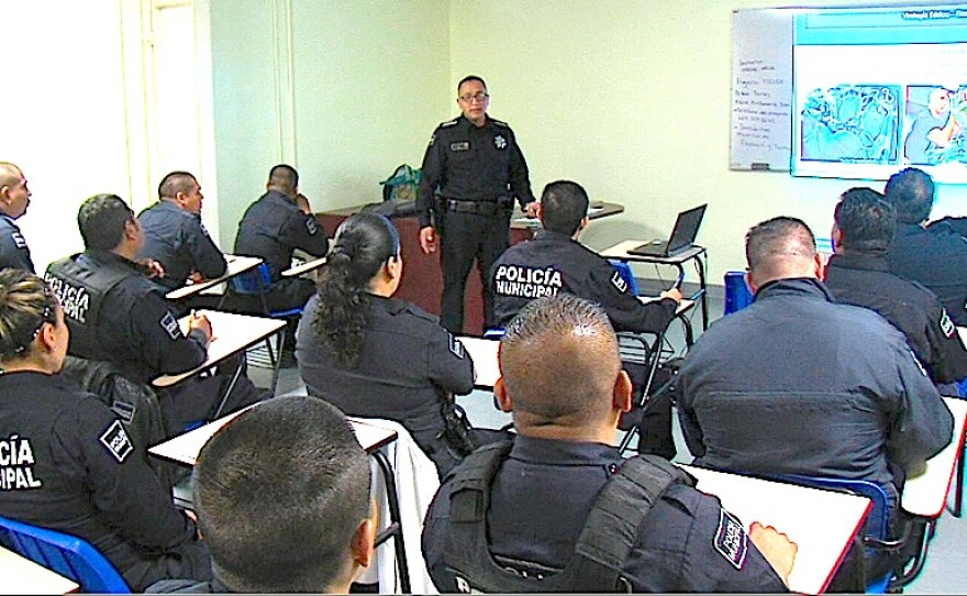 Tijuana police sub inspector Cesar Quinones talks to a roomful of officers at the police academy, April 25, 2015.