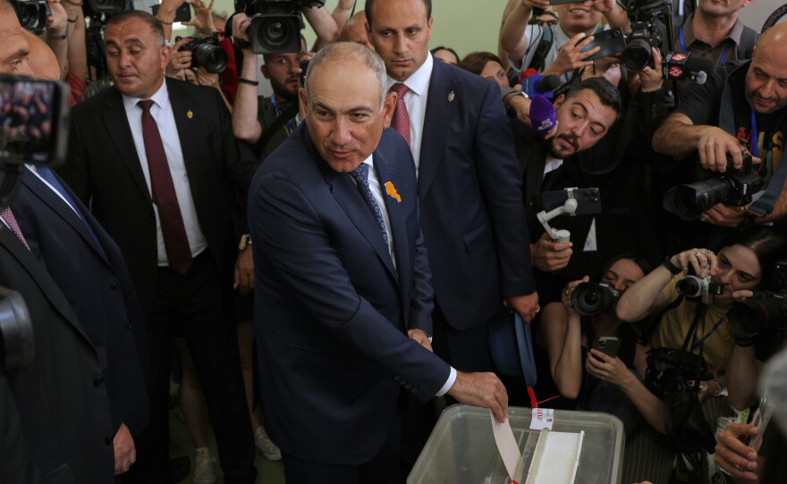 Armenian Prime Minister Nikol Pashinyan, center, casts his ballot at a polling station during the parliamentary election in Yerevan, Armenia, Sunday, June 7, 2026.