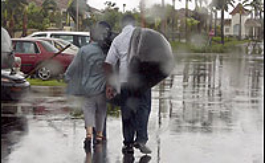 A couple leaves a storm shelter in West Boynton Beach, Fla.