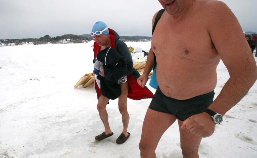 Silverio Bracaglia (left) and John Coningham-Rolls of London walk back to the warming hut after competing in the first U.S. Winter Swimming Championships at Lake Memphremagog in Newport, Vt.