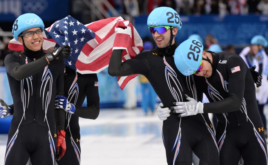 From left to right, America's J.R. Celski, Jordan Malone, Christopher Creveling and Eduardo Alvarez celebrate taking silver in the men's short track 5,000-meter relay at the Iceberg Skating Palace in the Sochi Winter Olympics Friday.
