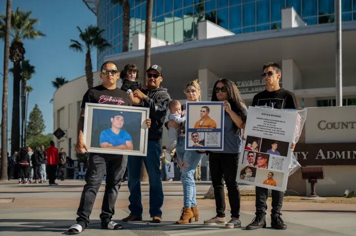 The family of Richard Matus Jr. stands outside the John F. Tavaglione Executive Annex with memorial photos of Richard, who died in-custody of the Riverside Sheriff’s Department in Riverside County. 