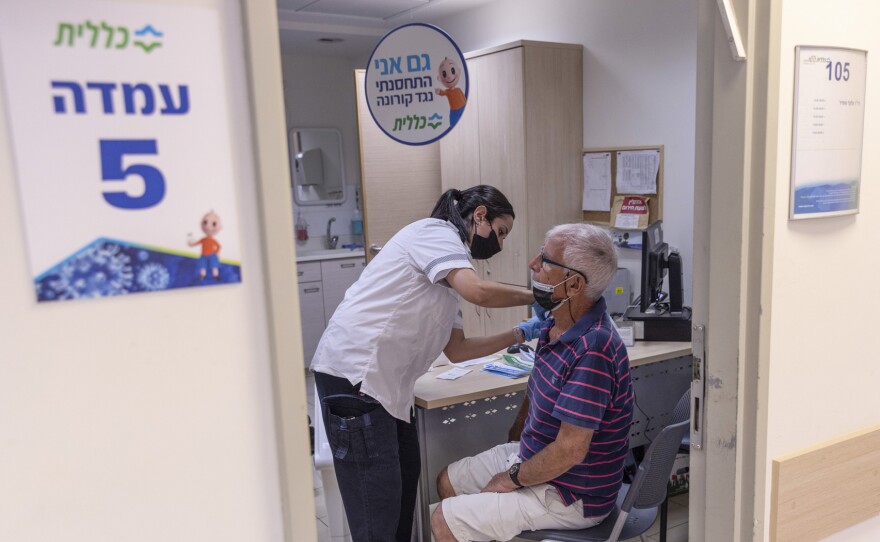 The director of WHO now says that a booster moratorium should be in force until 10% of the population in all countries is vaccinated. Israel had previously announced plans to give a third Pfizer dose to residents age 60 and up after an uptick in COVID cases. Above: Administering a booster on August 2 in Tel Aviv.