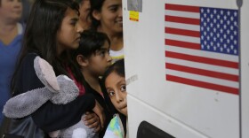 In this Tuesday, July 7, 2015 file photo immigrants from El Salvador and Guatemala who entered the country illegally board a bus after they were released from a family detention center in San Antonio. 