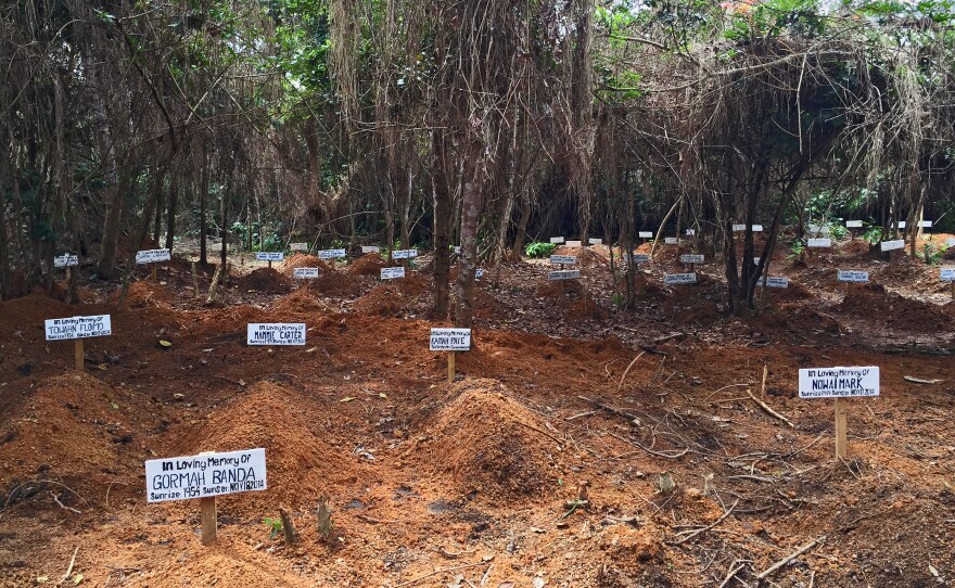 Each day a nurse comes to this clearing outside Taylortown, Liberia, to sing a song of mourning, preparing the space for the next burial. So far nearly 100 people are interred here.