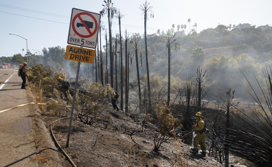 San Diego Fire Department crews put down a fire near Fairmont Avenue and Aldine Drive in San Diego, Calif., October 15, 2019.