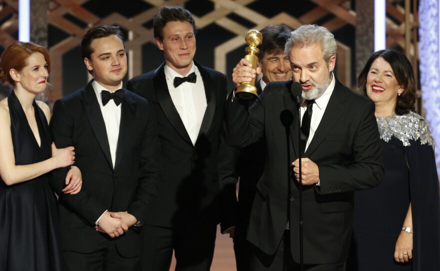 Sam Mendes accepts the award for best drama movie for 1917 at the Golden Globes on Sunday night.