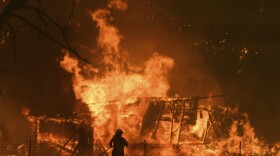 NSW Rural Fire Service crews fight the Gospers Mountain Fire as it impacts a structure at Bilpin, Australia Saturday, Dec. 21 ,2019. 