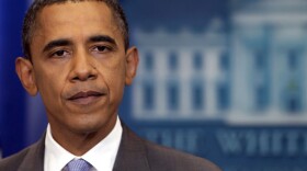 President Obama pauses as he speaks about the deal to raise the debt limit in the White House briefing room on Sunday.