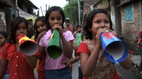 Child activists working with Amlan Ganguly, marching through the streets of Calcutta, using megaphones to spread health messages.