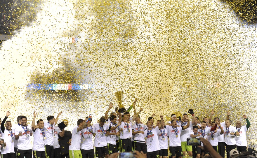 Mexico players celebrate their 3-1 win over Jamaica in the CONCACAF Gold Cup championship soccer match in Philadelphia, Sunday, July 26, 2015. 