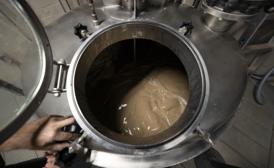 Master distiller Aaron Schorsch inspects the mash.