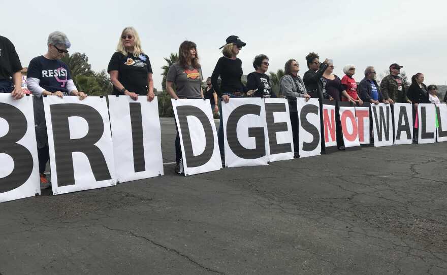 Demonstrators protest President Donald Trump's visit to San Diego at Our Lady of Mount Carmel, San Ysidro, March 13, 2018.