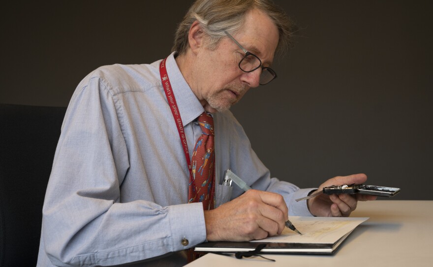 Art Lien demonstrates his illustration method. He uses graphite pencils and fills in with watercolors.