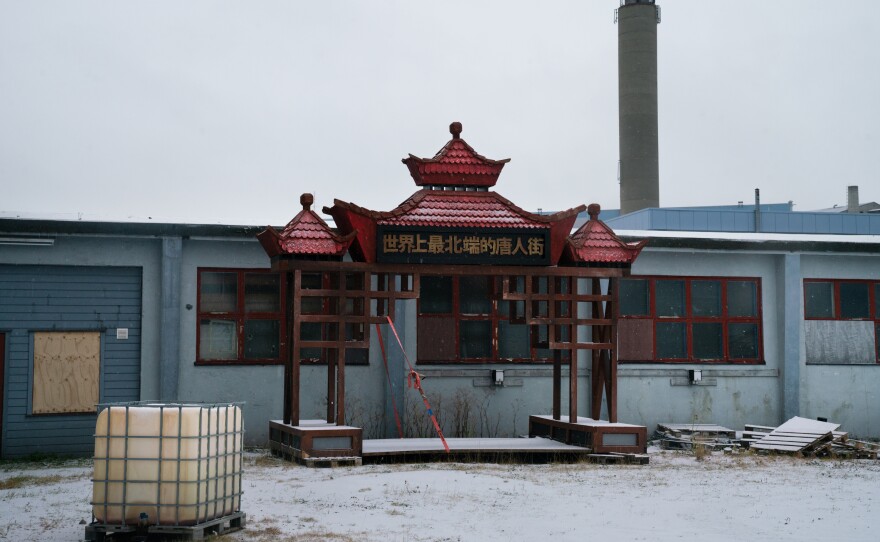 A gate used for the town's annual winter festival, called "Kirkenes, the world's northernmost Chinatown," sits in an open lot.