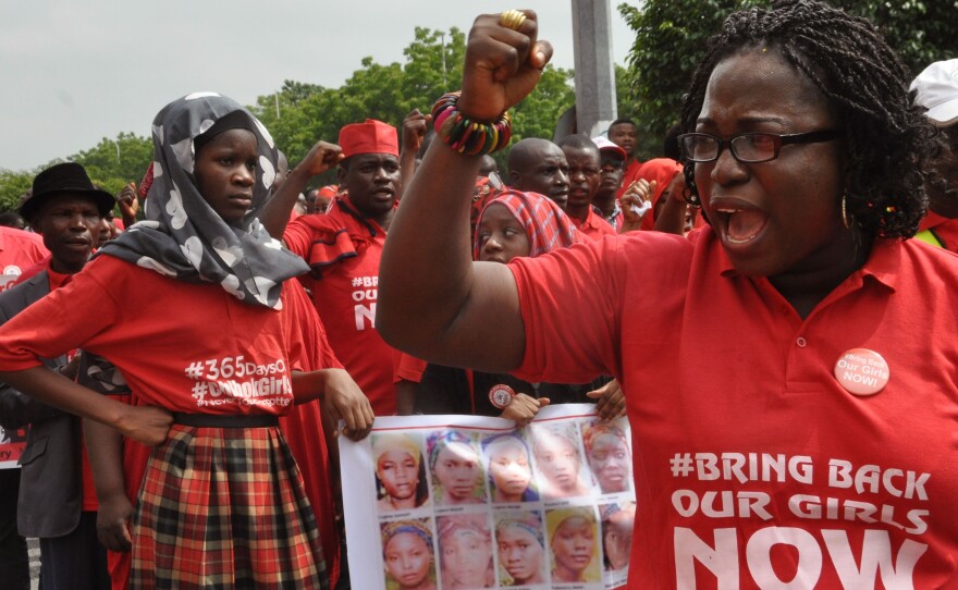 People take part in a march outside the presidential residence in Abuja in 2015, part of the Bring Back Our Girls campaign, in memory of girls abducted by Nigerian extremists.