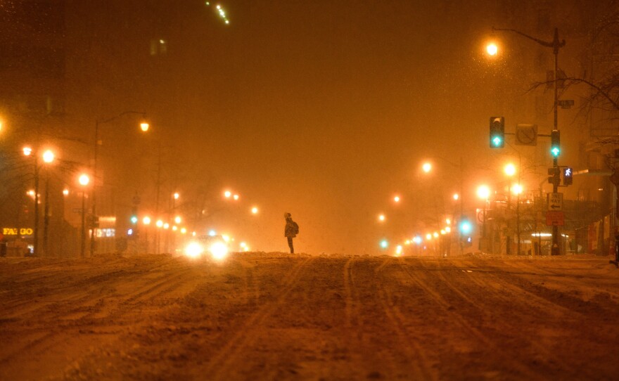A person waits to cross a street during a snowstorm in Washington, D.C., on Jan. 22.