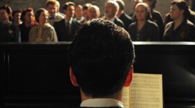 Re-enactment of Raphel Schächter playing piano in front of the Terezin Choir during a rehearsal.