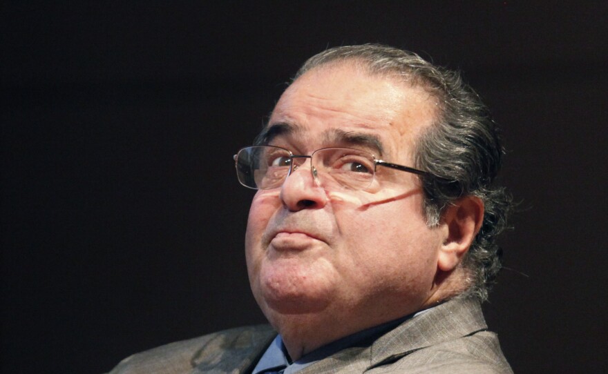 In this Oct. 18, 2011, file photo, U.S. Supreme Court Justice Antonin Scalia looks into the balcony before addressing the Chicago-Kent College of Law justice.