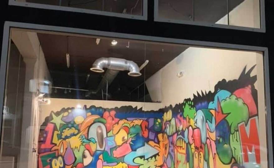 Carlos Galindo/Grvr mural as seen through the window of The Front in San Ysidro in August 2020.