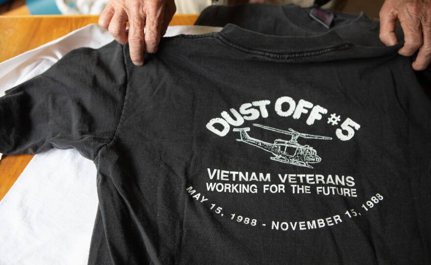Jack Lyons shows old T-shirts from his years working with Veterans Village of San Diego, May 22, 2022.