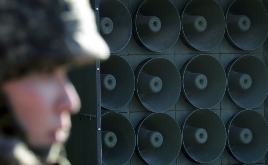 A South Korean soldier stands next to loudspeakers near the border with North Korea on Jan. 8. South Korea responded to the North's latest nuclear test by resuming the broadcasts that include news, criticism of the North Korean regime and pop music.