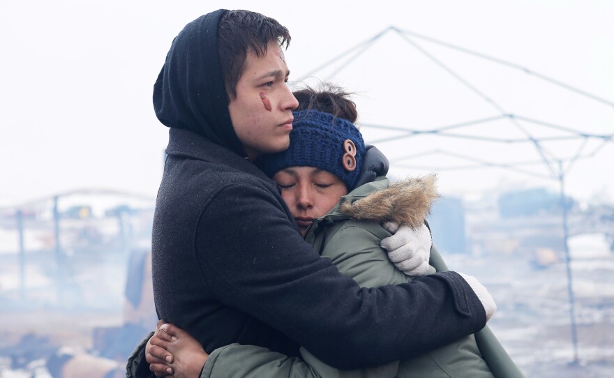 Alex Redbear and Kateri Eagle Staff embrace during a prayer ceremony at the Oceti Sakowin camp earlier today.