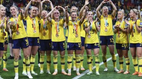 Sweden gesture to supporters as they celebrate with their bronze medals after defeating Australia in the Women's World Cup third place playoff soccer match in Brisbane, Australia, Saturday, Aug. 19, 2023.