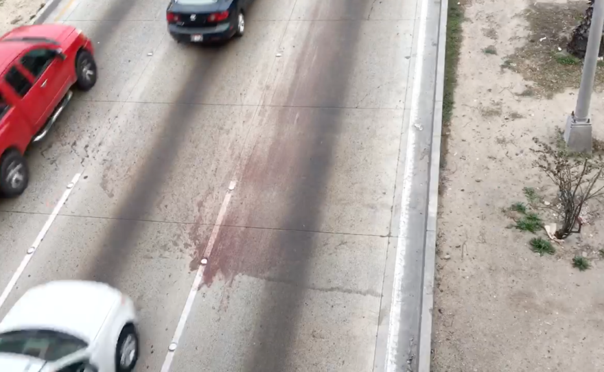 The Vía Rápida highway in Tijuana is stained with blood after a migrant was killed in a car collision, Jan. 18, 2016. 