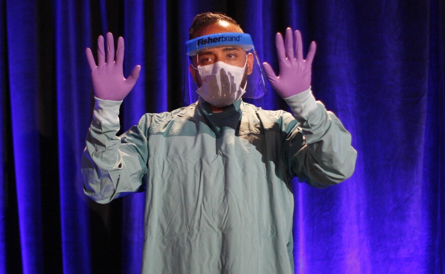 One of the most commonly heard Ebola acronyms is PPE, for personal protective equipment. Above, the proper way to don PPE is demonstrated at a CDC presentation. If you're not sure what CDC stands for, see the list of acronyms below.