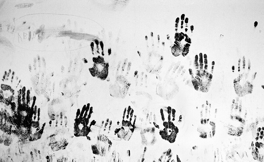 Handprints of children from the stateless Galjeel community in southeastern Kenya decorate a wall of an abandoned school.