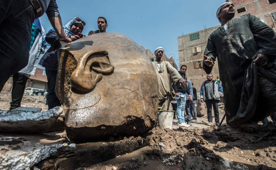 Egyptian workers look at the site of a new discovery by a team of German-Egyptian archaeologists in Cairo's Matariya District on Thursday.