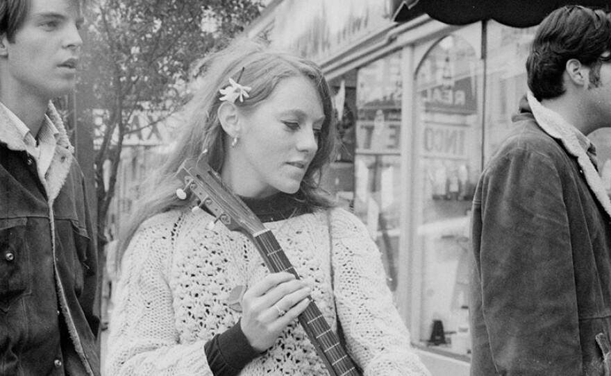 Here, a girl plays guitar in the Haight. In the summer of 1967, thousands of young people from across the country flocked to San Francisco's Haight-Ashbury district to join in the hippie experience, only to discover that what they had come for was already disappearing.