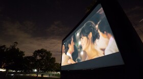 A photo of one of Street Food Cinema's outdoor screens. The film series screens cult classics and family favorites.