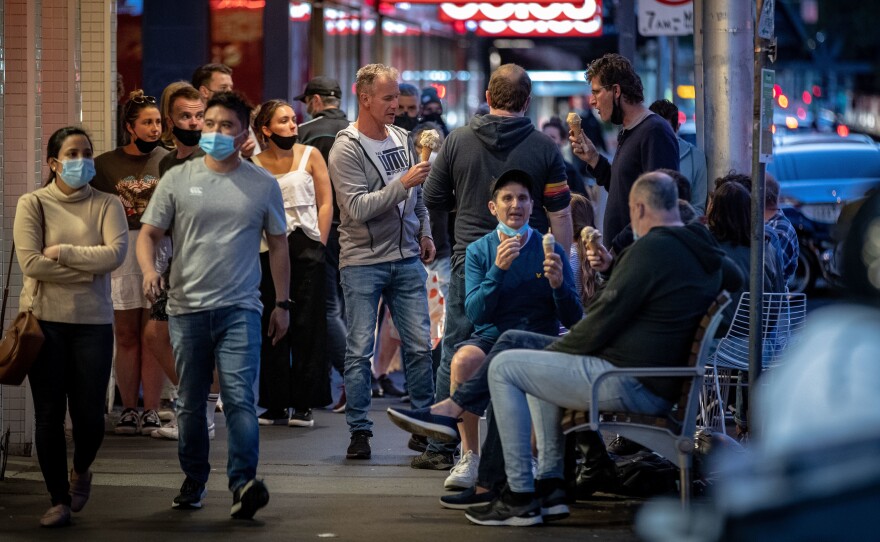 People enjoy eating outdoors on Wednesday in Melbourne, Australia. Lockdown restrictions in the city were lifted after 111 days, allowing people to leave their home for any reason.