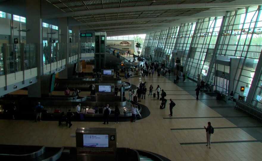 Travelers are seen from overhead in the Terminal 2 baggage claim area on August 28, 2023.