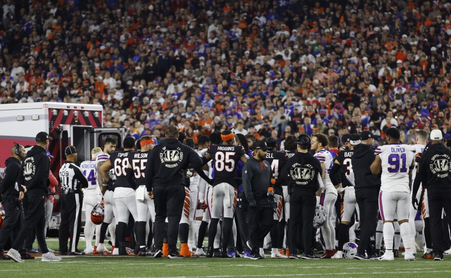 Players look on Monday as Damar Hamlin of the Buffalo Bills is treated by medical personnel at Paycor Stadium in Cincinnati, Ohio.