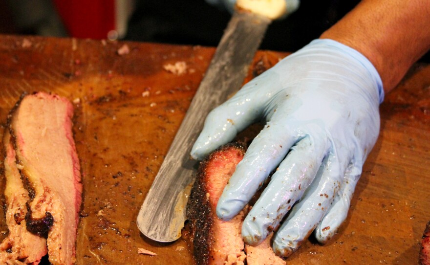 Slicing brisket at Franklin Barbecue in Austin, Texas. The new-found interest in all-wood barbecuing has a lot to do with the success of Aaron Franklin, owner of Franklin Barbecue.