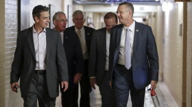 Rep. Justin Amash, R-Mich., far left, and Rep. Doug Collins, R-Ga., far right, head to a meeting with fellow Republicans on Capitol Hill in Washington, Friday, July 14, 2017, to reconcile the GOP's long-overdue budget blueprint, even as divisions between moderates and conservatives over cutting programs like food stamps threaten passage of the measure. 