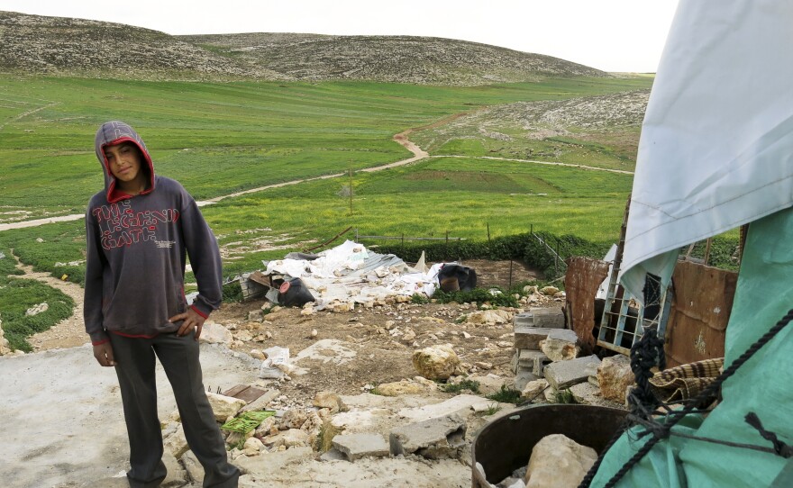 Majid Banifadel, 16, stands in the remains of his family home.