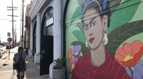 A woman walks in front of the La Bodega Gallery in Barrio Logan, Dec. 5, 2019.