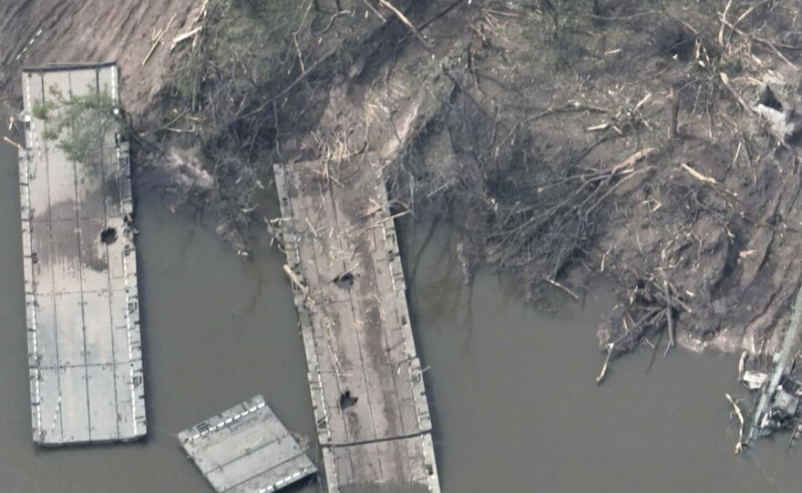 This handout photo provided by the Ukraine Armed Forces on Thursday is said to show a ruined pontoon crossing with dozens of destroyed or damaged Russian armored vehicles on both banks of the Siverskyi Donets River after their pontoon bridges were blown up in eastern Ukraine.