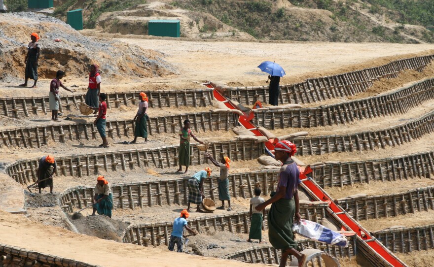 Rohingya day laborers terrace a hillside on the edge of the world's largest refugee camp in Bangladesh.