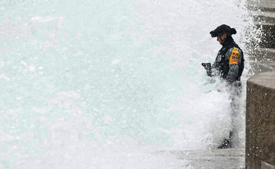 A National Guard stands in the spray as a wave hits the seawall brought by the approaching Hurricane Simon in Puerto Vallarta, Mexico, Sunday, Oct. 11, 2026.