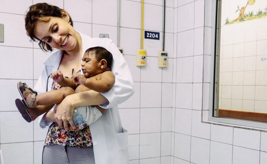 Dr. Regina Coeli holds 4-month-old Enzo Thamires in an examination room of the Oswaldo Cruz public hospital in the Brazilian city of Recife.