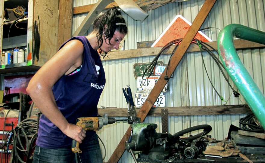 Shelby Miller tools on a part for a car for the derby. Miller comes from a derby family — her mother, father, and brother all participate.
