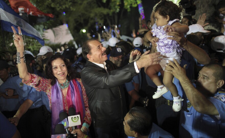 Nicaragua's President Daniel Ortega (center), accompanied by his wife Rosario Murillo, greets supporters in 2011. She has long been a prominent figure, and now Ortega has made her his vice presidential running mate as he seeks a third term in Sunday's election.