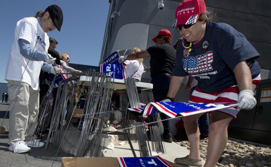 Mary Jo Trapani, a volunteer for Republican presidential candidate Donald Trump, gathers posters for a campaign rally in Hagerstown, Md. The Republican National Committee credits a strong network of local campaign staff and volunteers along with millions of door knocks and phone calls for victory up and down the ballot last week.